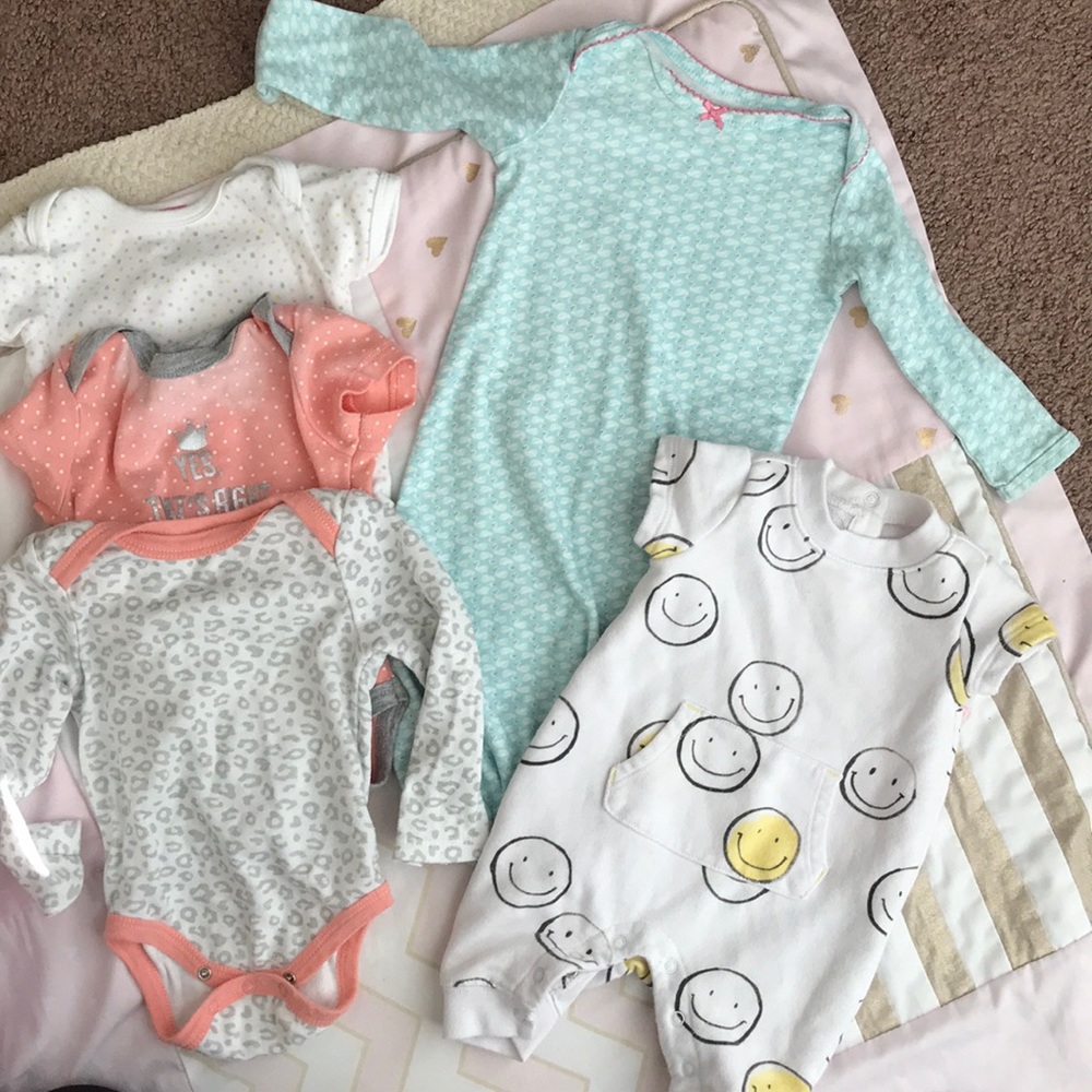 Bundle of onesies, romper, and sleep sack shirt